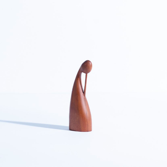 Hand carved walnut sculpture in the form of a female figure