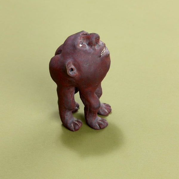 Surreal ceramic anthropomorphic sculpture of head with four legs