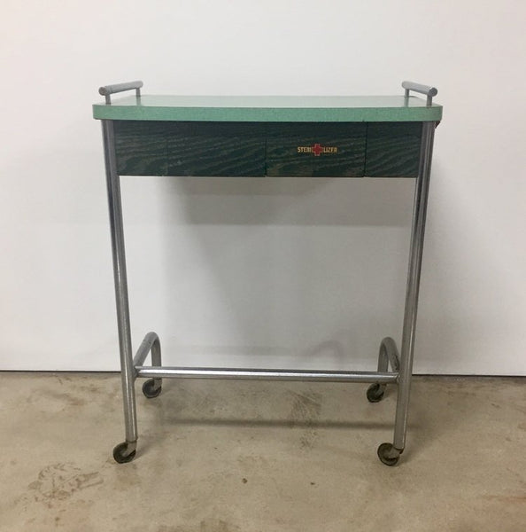 Vintage industrial tubular steel rolling stool and cantilevered table